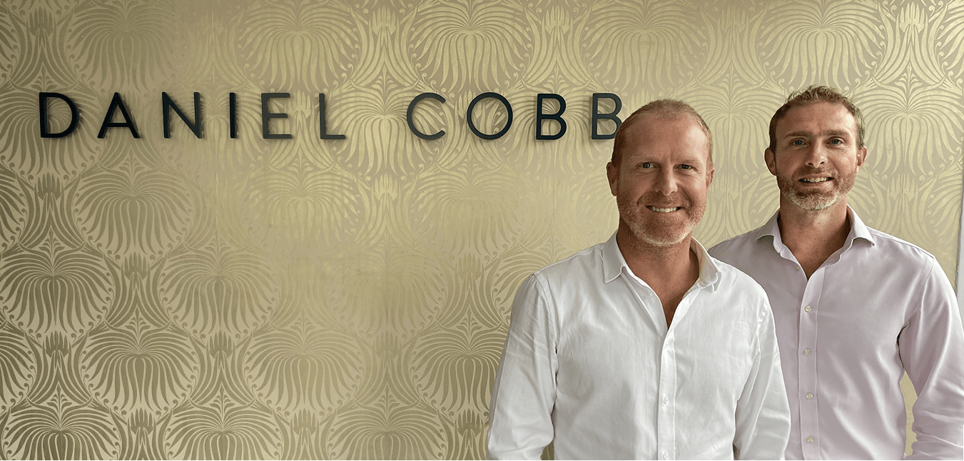 Geroge cobb at new office with the DC sign behind